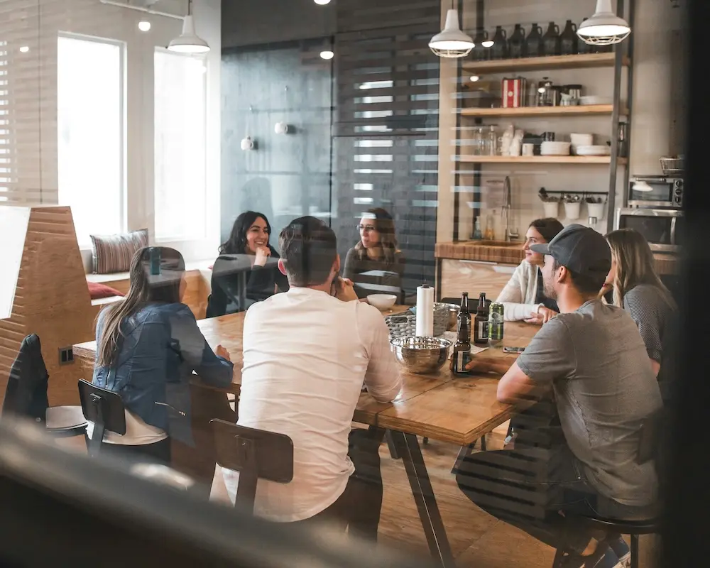 Menschen sitzen um einen Tisch im Büro
